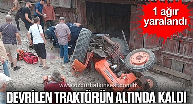 Devrilen traktörün altında kalan sürücü ağır yaralandı