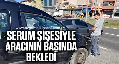 Kaza yaptı, serum şişesiyle aracının başında bekledi