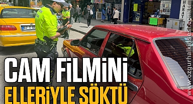 Cam filmini elleriyle söktü
