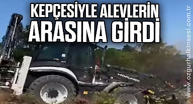 Kepçesiyle alevlerin arasına girdi